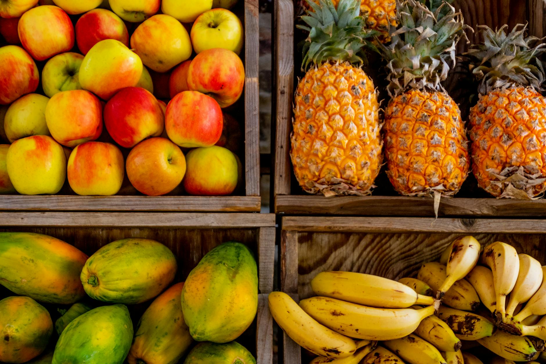 four trays of varieties of fruits